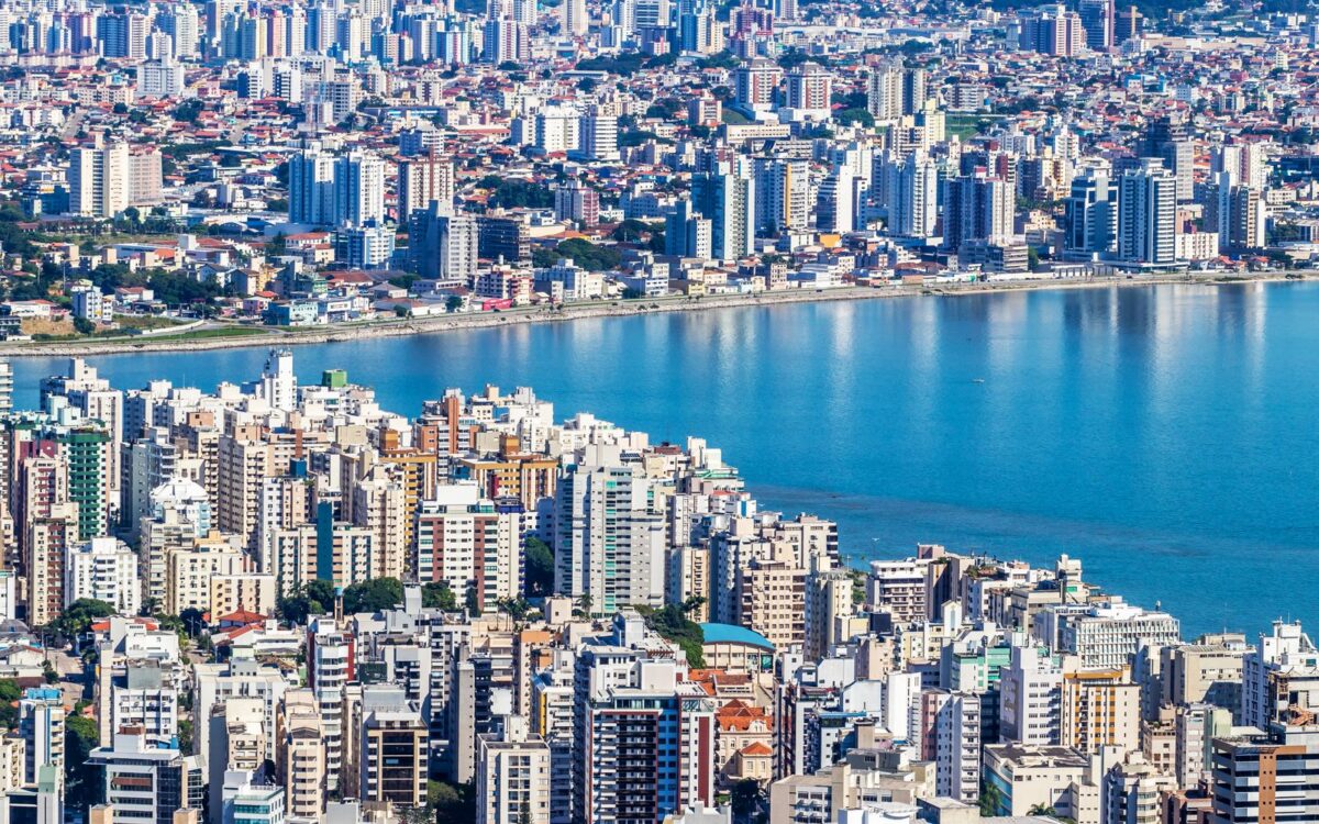 Vista aérea dinâmica de Florianópolis, Brasil, mostrando a orla urbana e paisagem urbana vibrante